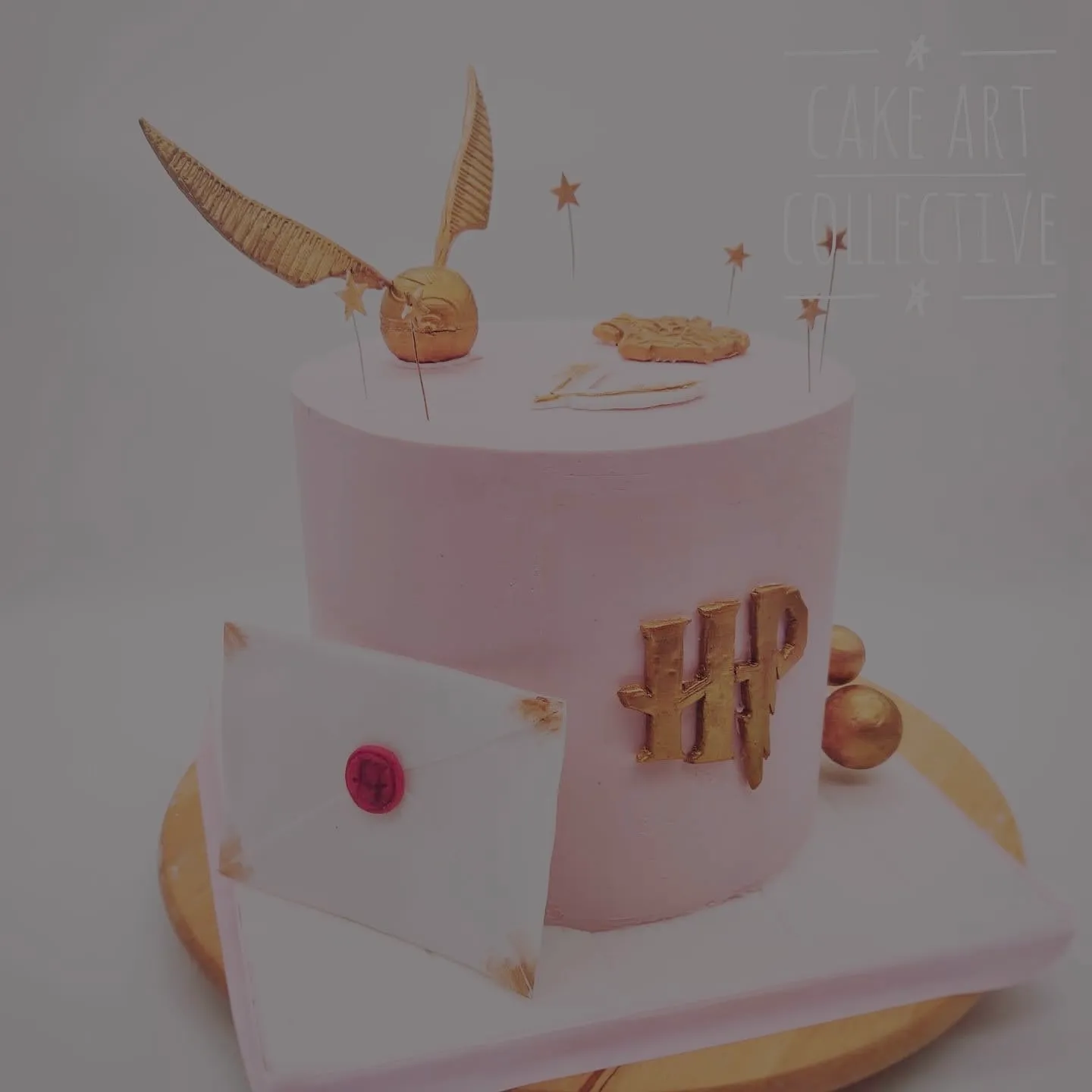 Full view of pink Harry Potter birthday cake showing all tiers and decoration details