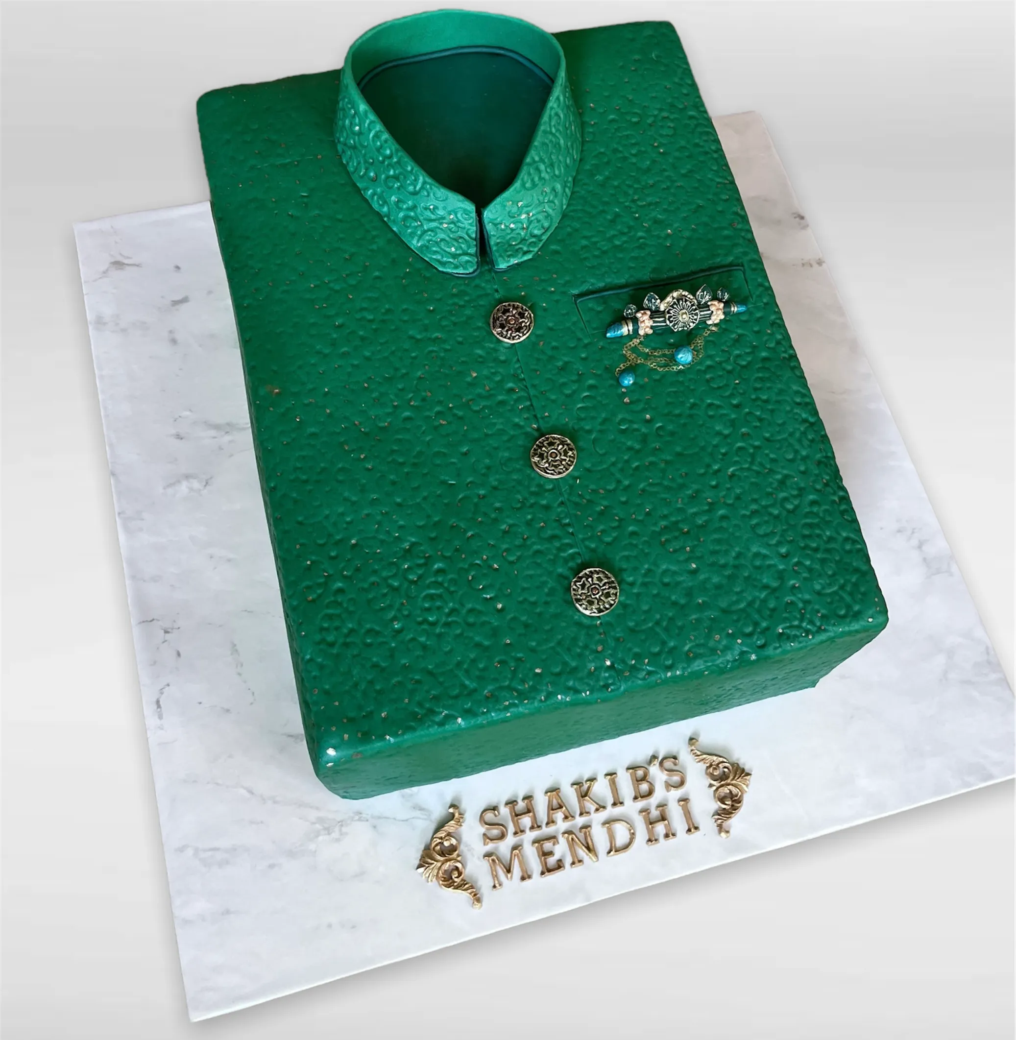 Sculpted mendhi celebration cake with ornate sherwani design and intricate patterns