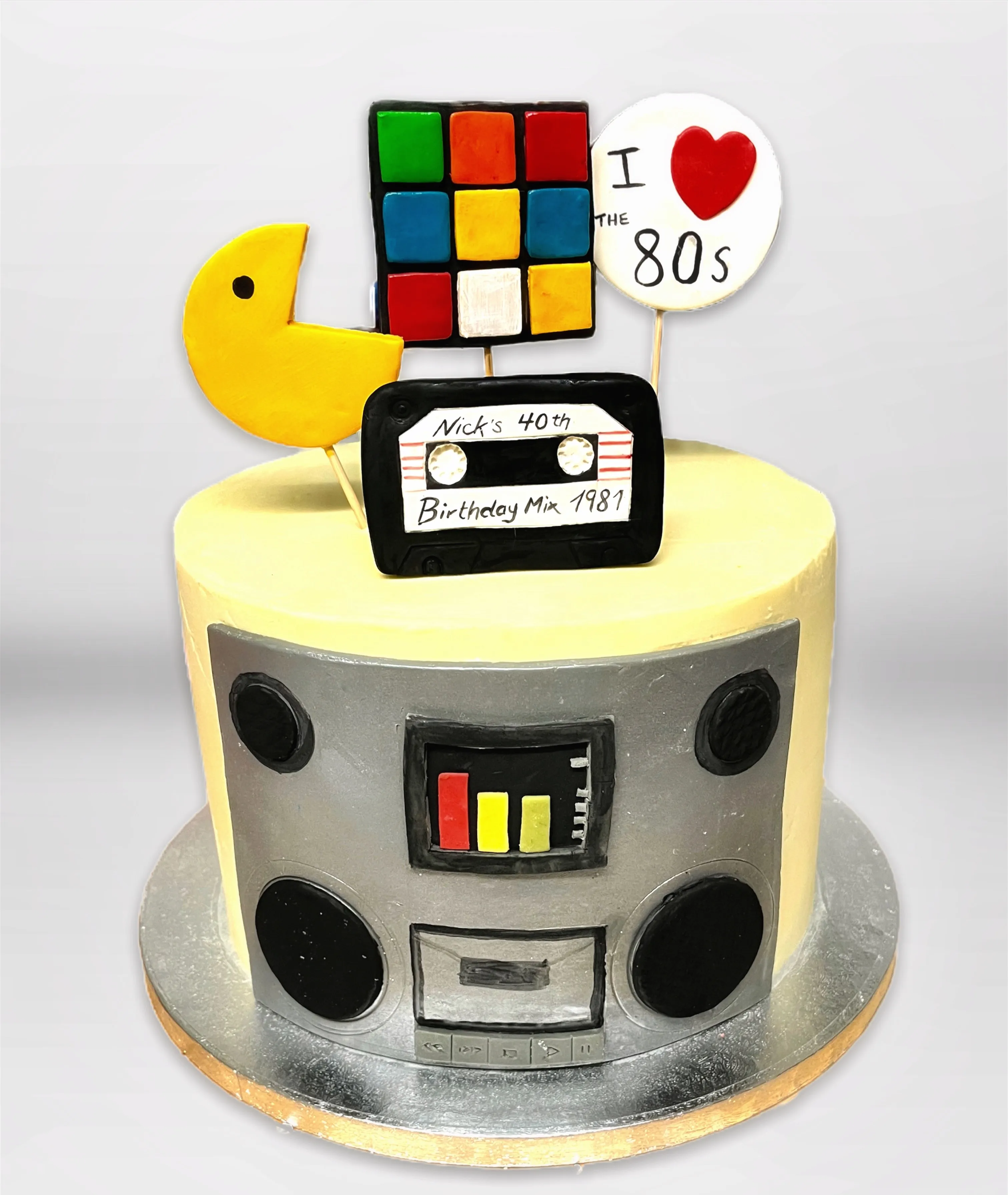 Retro 80s birthday cake shaped like a boombox with vibrant neon colours and cassette details
