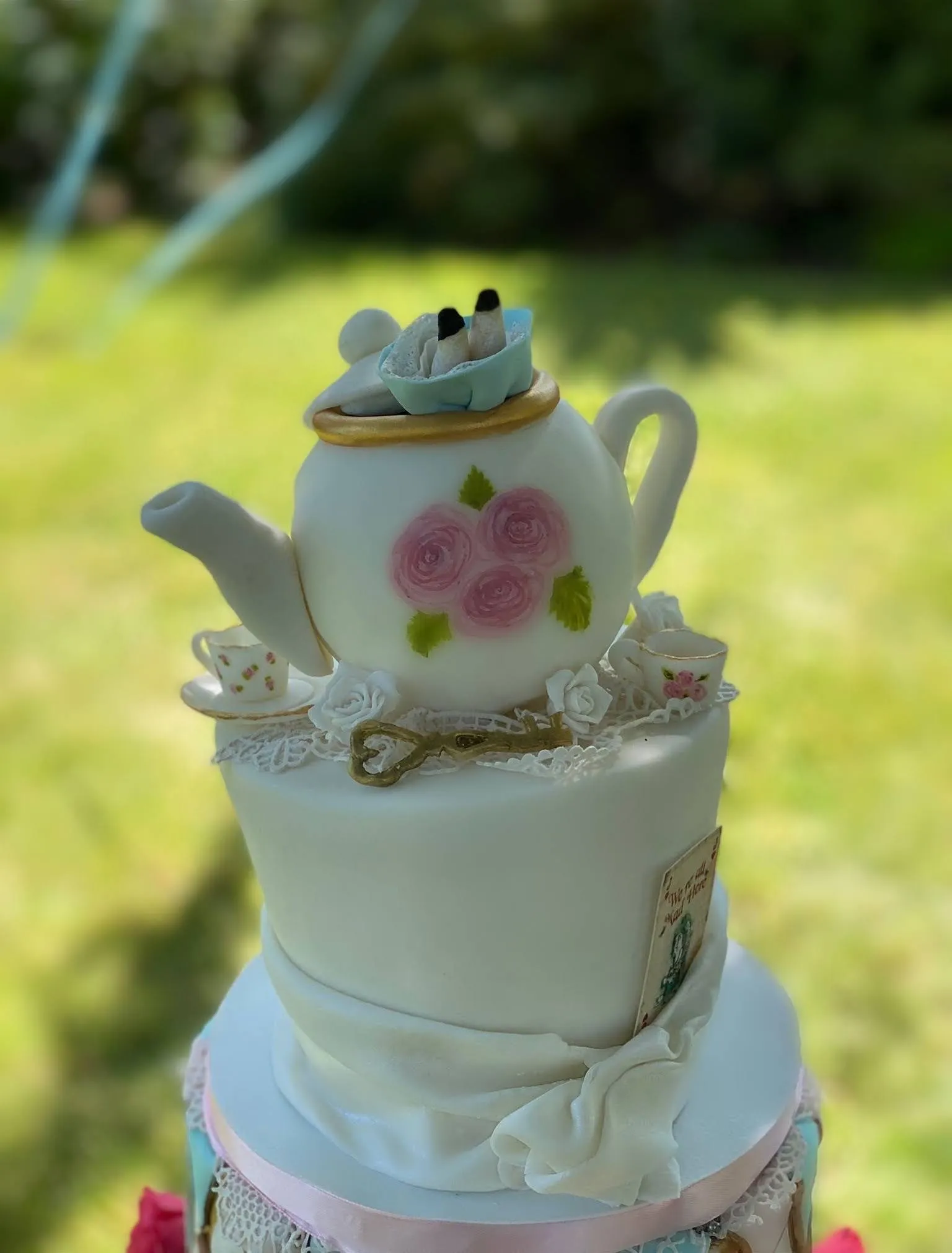 Close-up of sculpted Alice in Wonderland teapot with hand-painted details