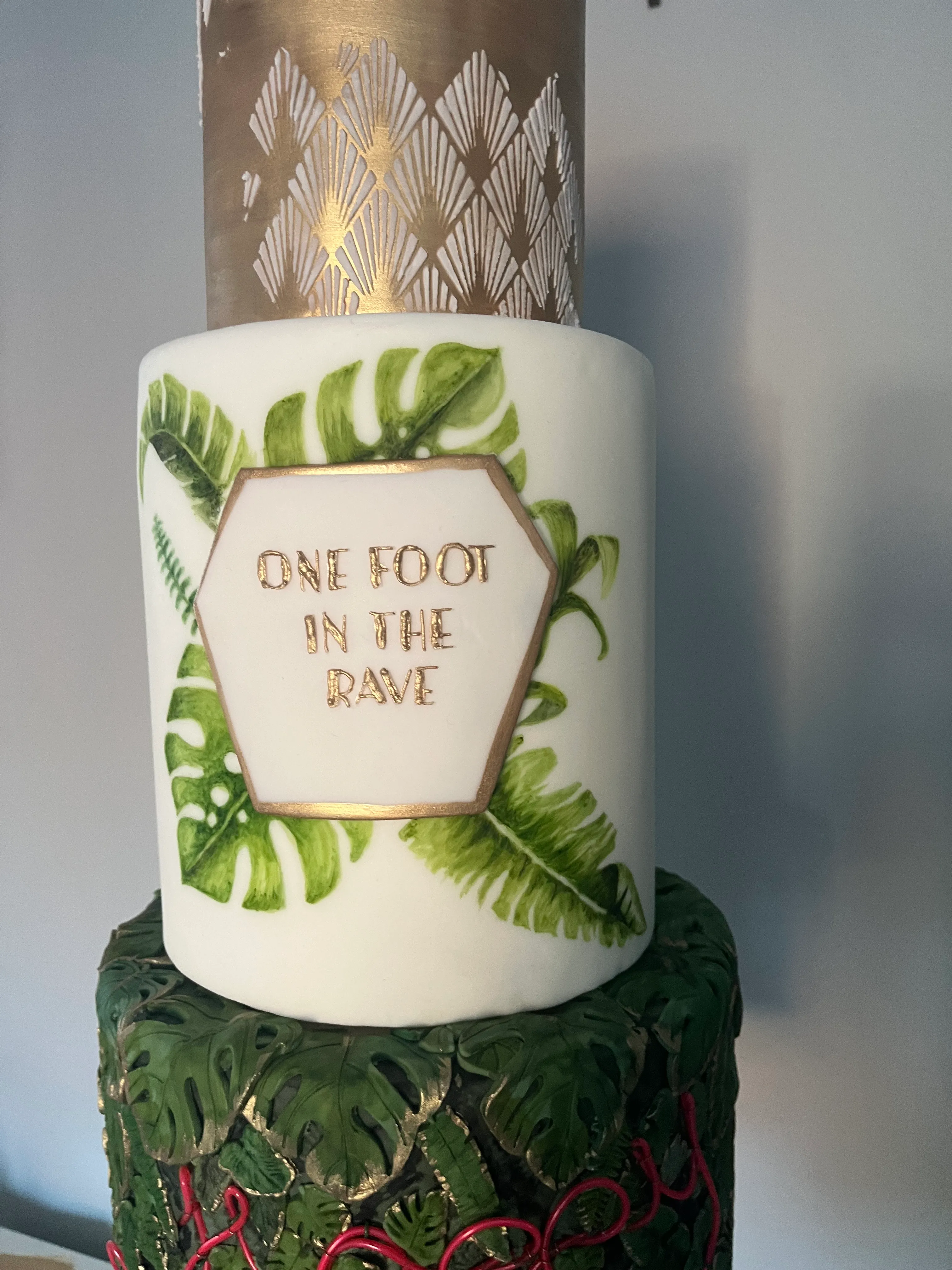 Tropical birthday cake with hand-painted monstera leaves and botanical details